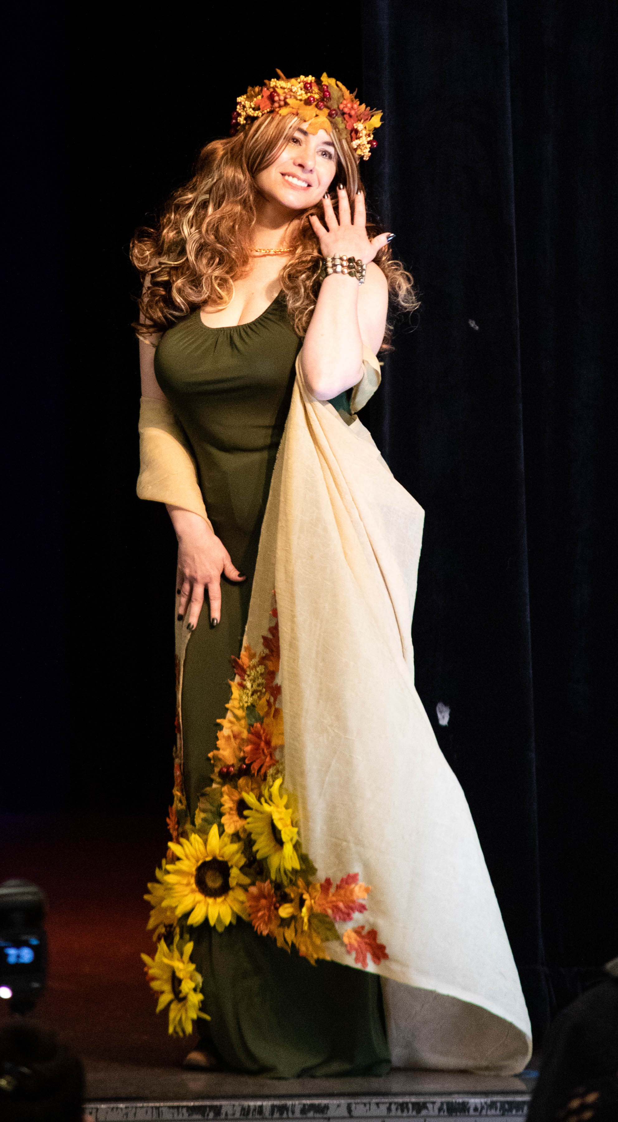 Slay the Runway participant models a Mother Earth inspired ensemble, featuring garland of flowers and beige robe embellished by flowers.