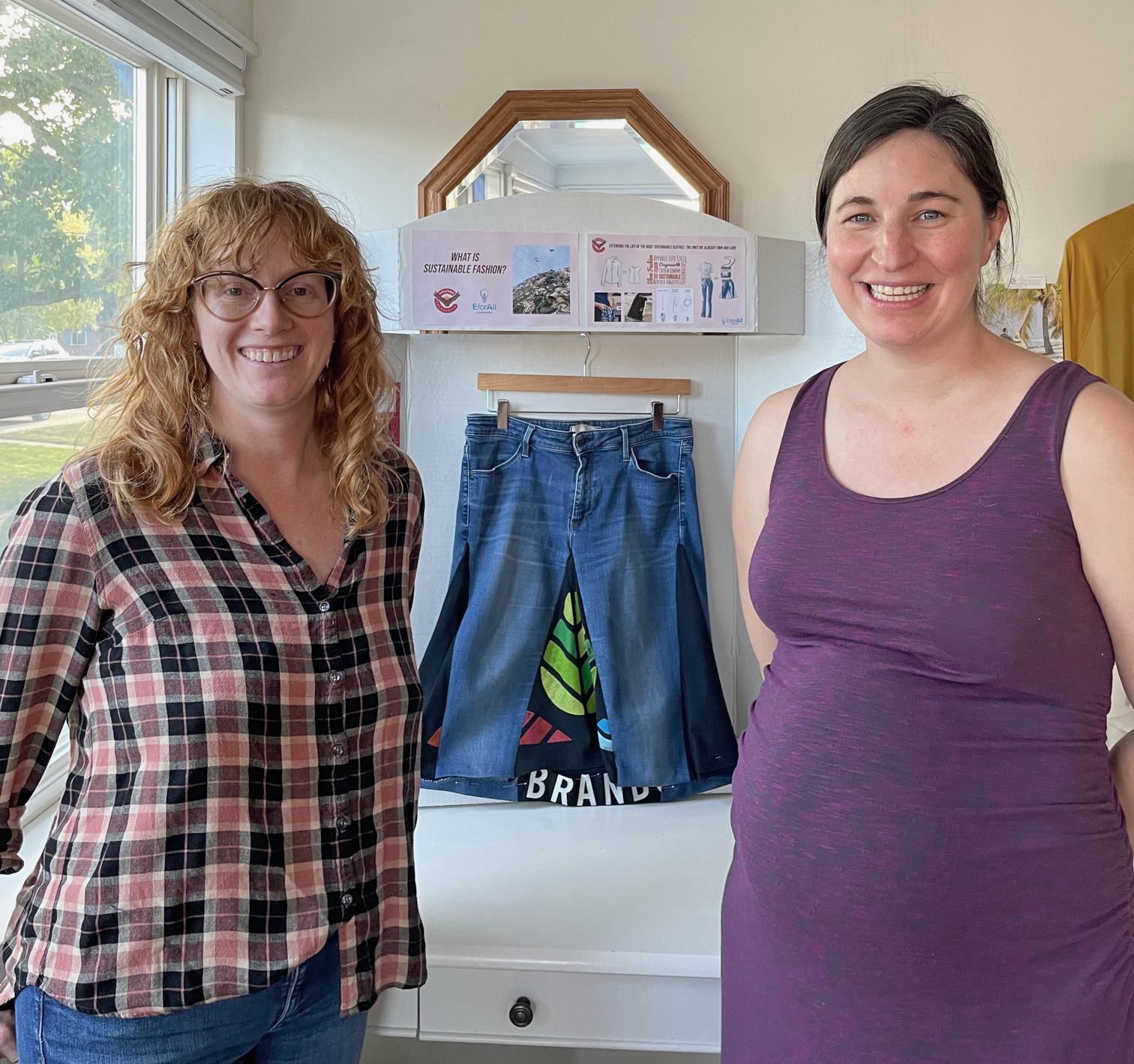 Jackie and Jessica, Co-Founders of Vulture Collective, smile for the camera at their first event, a clothing swap.  Jessica is visibly pregnant.